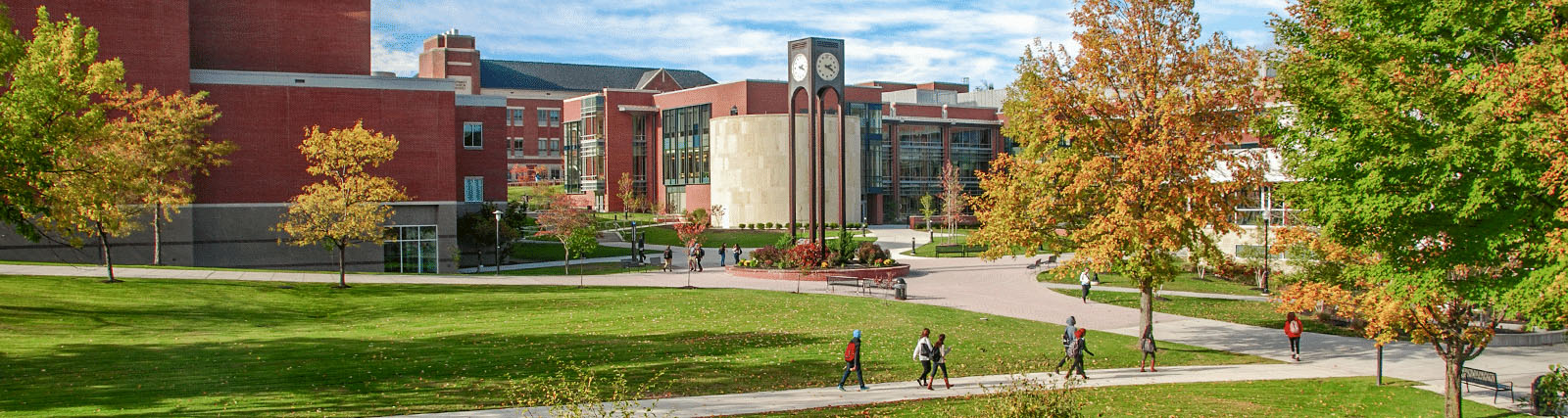 clocktower quad in fall, CCIT 和 PAC in background, students walking on sidewalks