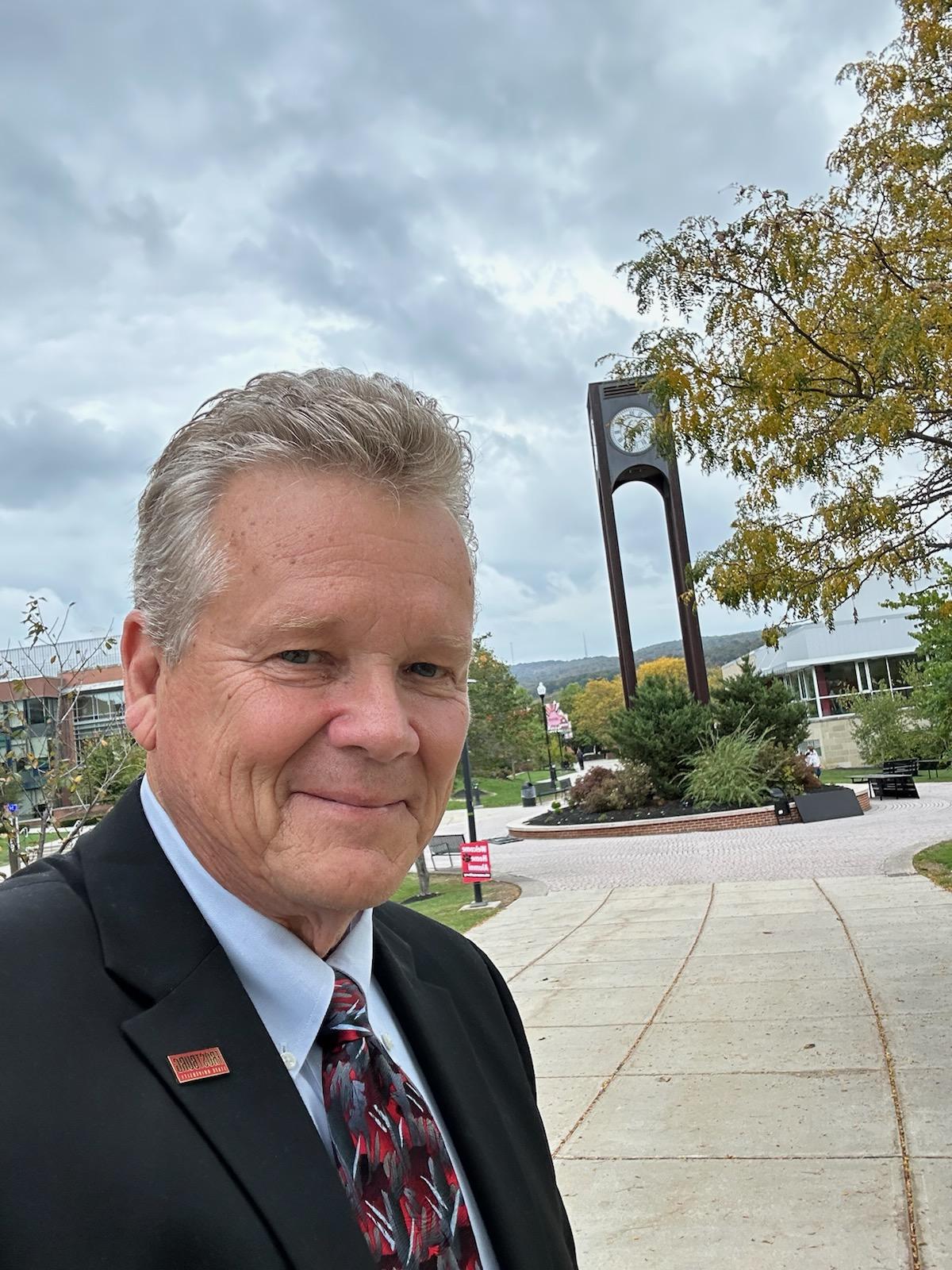 Joe Lambert with clock tower in background